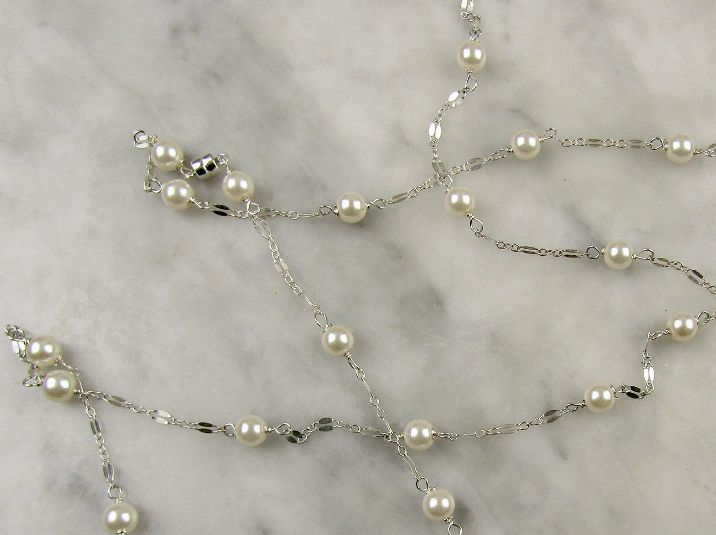 Long delicate sterling silver and pearl necklace, the necklace is 50 inches longwith a sterling silver magnetic clasp closure