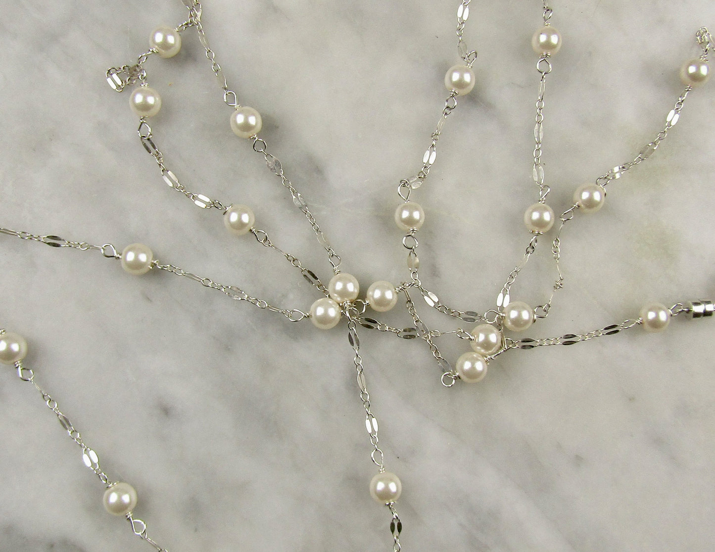 Long delicate sterling silver and pearl necklace, the necklace is 50 inches longwith a sterling silver magnetic clasp closure
