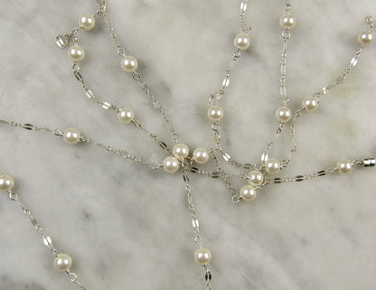 Long delicate sterling silver and pearl necklace, the necklace is 50 inches longwith a sterling silver magnetic clasp closure