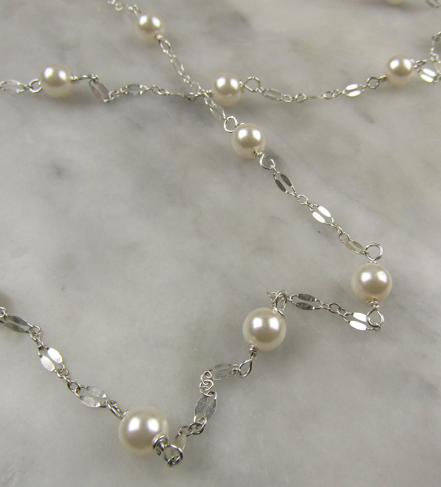 Long delicate sterling silver and pearl necklace, the necklace is 50 inches longwith a sterling silver magnetic clasp closure