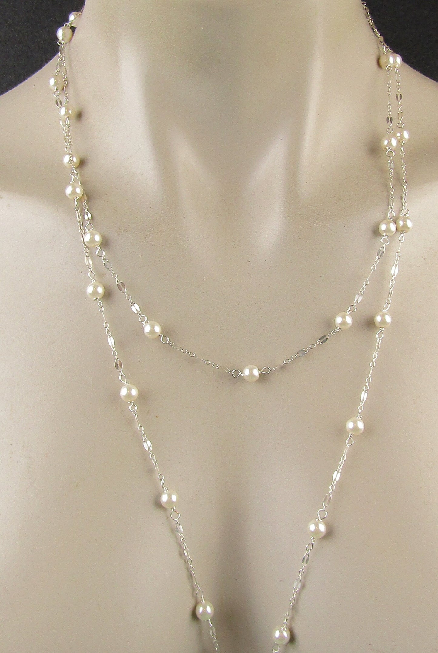 Long delicate sterling silver and pearl necklace, the necklace is 50 inches longwith a sterling silver magnetic clasp closure