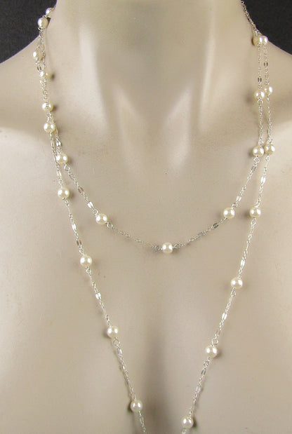 Long delicate sterling silver and pearl necklace, the necklace is 50 inches longwith a sterling silver magnetic clasp closure